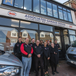 Associated Garage Doors team members standing in front of showroom