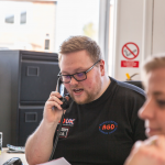 Associated Garage Doors customer support team member on phone chatting to customer