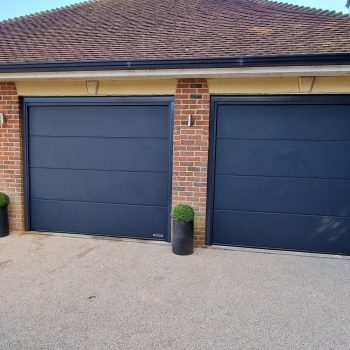 Three matching automated roller garage doors