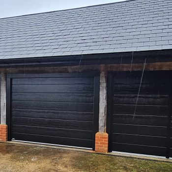 Two up and over garage doors next to a side hung garage door